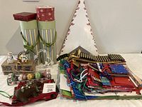 Photo showing assorted Christmas gift bags, small figurines, striped gift boxes, and a large fold-out star card