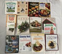 Photo of 16 cookery and outdoor wedding books arranged in four rows on a white surface.