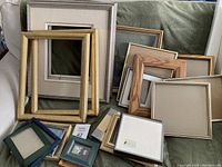 Multiple frames arranged on sofa or surface, showcasing variety and sizes