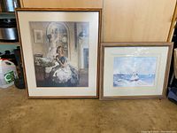 Two framed artwork prints side by side on floor, showing full frames and images.