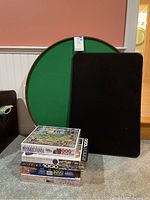Round felted game tray on Lazy Susan, rectangular felted puzzle board, and stack of five 1000-piece puzzles.
