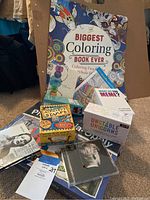 Photo showing The Biggest Coloring Book Ever, Alphabet Stamps set, What Do You Meme?, Unstable Unicorns and Taylor Swift CD cases