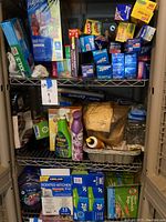 Photo of upper shelves with assorted Ziploc bags, Glad cling wrap, cleaning sprays, air freshener, and paper food wraps