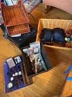 Overview photo showing Pixma printer, wicker baskets, black neck massager, blue folder tray, and various watches and small items in baskets and trays.