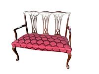 Front view of wooden bench showing carved backrest and upholstered seat with red patterned fabric
