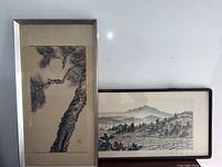 Both framed prints displayed side by side against white wall