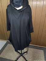 Front view of the black Joseph Ribkoff jacket on a mannequin showing unique collar and overall style.