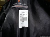 Photo of the brand label and retail tag inside the coat showing size 16, color red, and price $698.