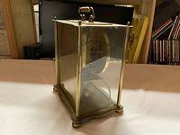 Side angle showing brass frame and missing glass panel.