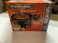 Front of Proctor Silex slow cooker box showing product image, 4 quart capacity, removable stoneware, and settings.