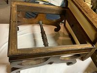 Top view of the footstool frame showing the wooden rectangular frame and spindle support under the cushion area.