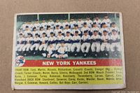 Front side of the 1956 Topps New York Yankees team card showing the team photo and player names and staff.