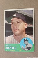 Front of card showing Mickey Mantle portrait, green name panel and inset action photo