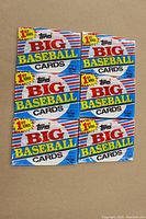 Front view of 6 unopened 1988 Topps Big Baseball Cards cello packs grouped in two columns. Each pack labeled as first series, with bright colors and Topps branding.