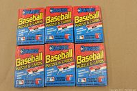 Front view of six unopened 1989 Donruss Baseball wax packs arranged in two rows of three, showing bright red, yellow, and blue packaging with Donruss branding and puzzle & cards text.
