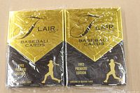 Front view of two factory sealed 1993 Flair Premiere Edition baseball card packs. Black and gold design with stylized baseball player and Flair Ltd logo.