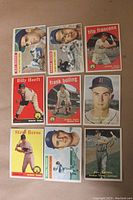 A photo displaying nine Detroit Tigers baseball cards from the 1950s Topps sets featuring various players and card designs, showing fronts of cards with players in pitching, batting, and portrait stances.