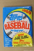 Single unopened wax pack of 1989 Topps Major League Baseball cards showing front with promotional text and branding.