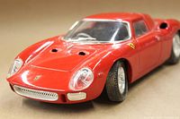 Front side angle showing red painted die cast Ferrari 250 LM model car with detailed headlight and grille.