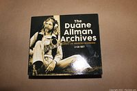 Front cover of the 3 CD set showing Duane Allman sitting with a guitar, titled The Duane Allman Archives Classic Live Broadcast Recordings.