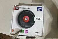 12 inch Dual subwoofer in original white box with red and black branding, rated 1000 watts, model DWS12 visible on box.
