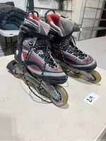 Side view of the pair of K2 Catalyst roller blade skates showing the wheels, boot, laces, and buckle system.