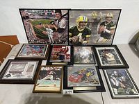 Overview of the 10 framed sports pictures arranged on the floor showing different athletes and sports.