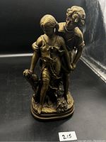 Front angled view showing detailed faces, clothing, and the sheaf of wheat held by the boy.