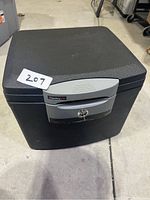 Full view of black Sentry Safe locking safe on concrete floor with key lock and locking panel visible.