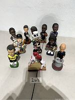Multiple sports and character figurines arranged on a surface showing the full lot collection.