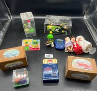 Wide view of all vintage toys including Marvin the Martian figurines, dolls, vending machines, and collectible wooden boxes.