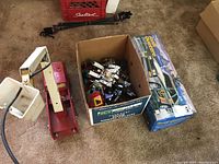Tonka fire engine, box of Transformers and Audi Quattro box on carpet