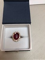 Ring in blue and white presentation box, top view