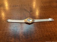 Full view of watch laid flat showing bracelet, case and dial