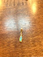 Front view of pendant on wooden surface