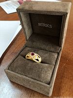 Ring displayed upright in Birks suede presentation box