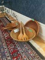 Three bowls together on floor with two server sets