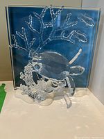 Front view of entire crystal sculpture on glass panel