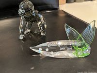 Gorilla figurine and Endangered Wildlife plaque on black surface