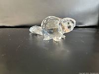Side angle view of the Swarovski crystal beaver figurine showing its detailed faceted body and smooth tail.