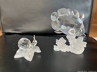 Both crystal figurines on black background showing full overview