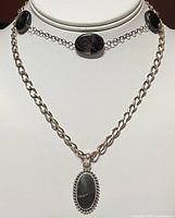 Photo showing two necklaces together on a display bust, highlighting both the 20-inch beaded black agate necklace and the shorter silver chain with pendant.