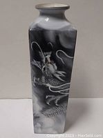 Front and side view of square Noritake Toki Kaisha vase with black and white dragon design and clouds, showing intricate detail.