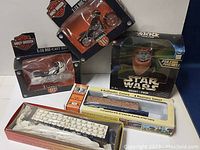 Five collectible items including two Harley Davidson die-cast motorcycles, Star Wars Wicket Ewok figure, and two HO scale train models