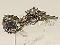 Side view of the pipe showing dragon carving wrapping from bowl to stem.
