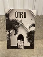 Cover of the OTR II photobook showing Beyoncé and Jay Z in front of a church in black and white.