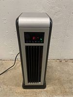 Front view of the tower fan and heater unit showing digital temperature display and control buttons.