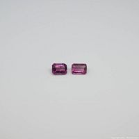 Two emerald cut pink tourmaline gemstones shown side by side on white background.