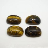 Four saddle cut Tiger Eye gemstones arranged in two rows showing front and back views; brown color with natural patterns and holes visible.