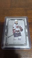 Front side of hockey card showing Connor Bedard in uniform with name and star rating at bottom.